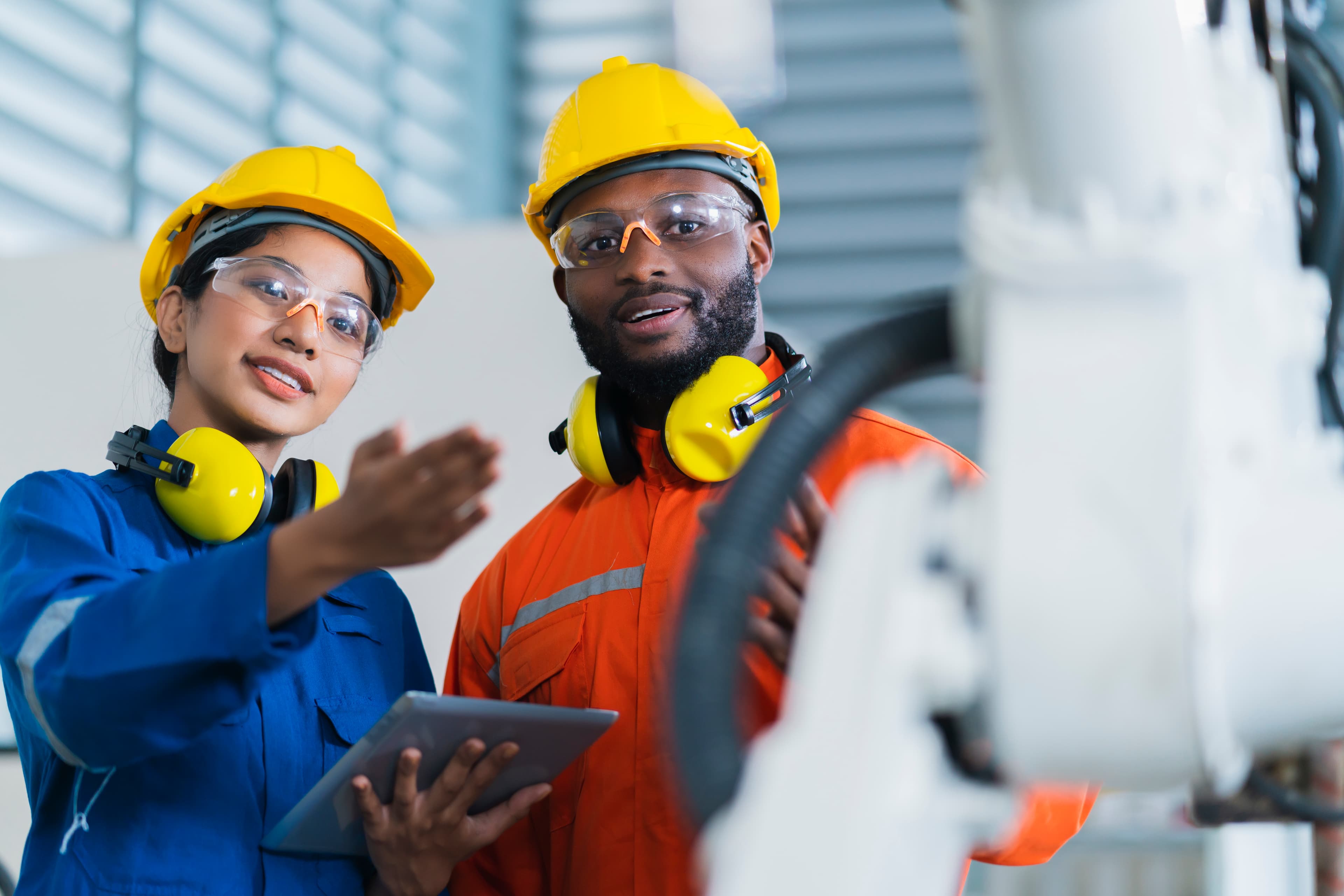 Two engineers operating industrial machinery together